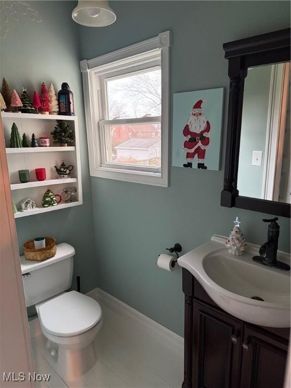 bathroom with tile patterned flooring, vanity, and toilet