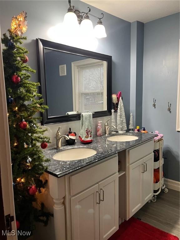 bathroom featuring hardwood / wood-style floors and vanity