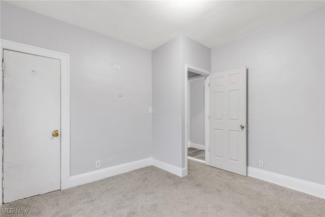 unfurnished bedroom with light colored carpet