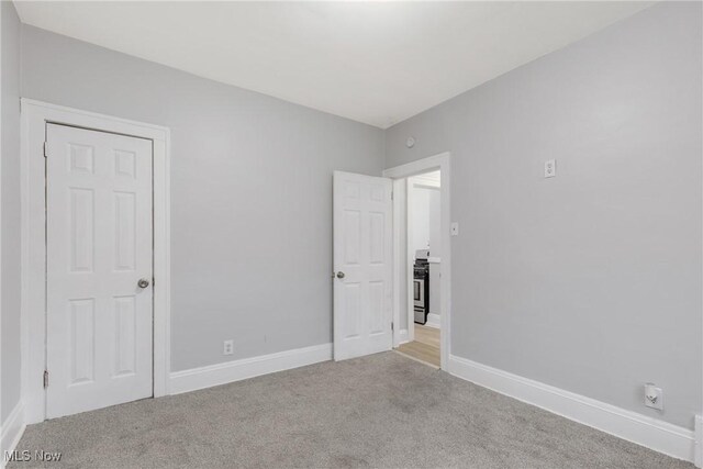 unfurnished bedroom featuring light carpet