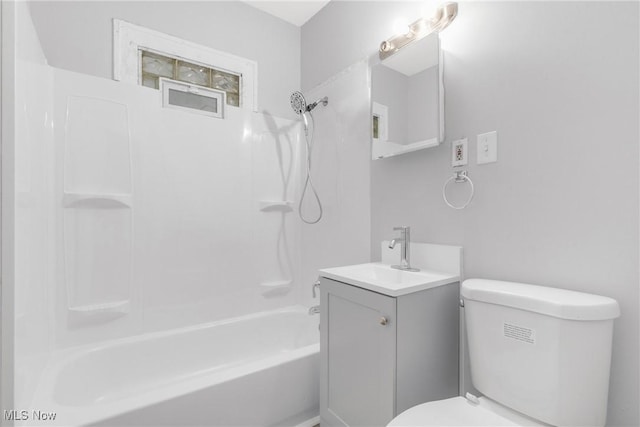 full bathroom featuring bathing tub / shower combination, vanity, and toilet