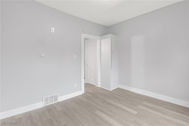 empty room with light hardwood / wood-style flooring