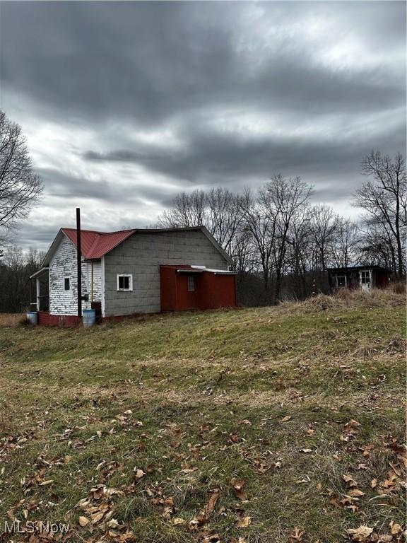 view of side of home featuring a lawn