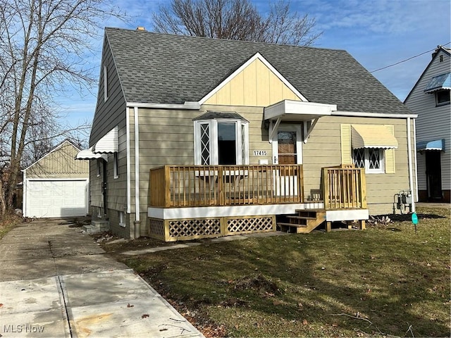 back of house with an outbuilding, a yard, and a garage