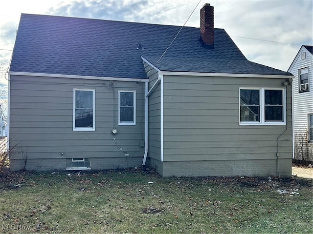 rear view of house with a lawn