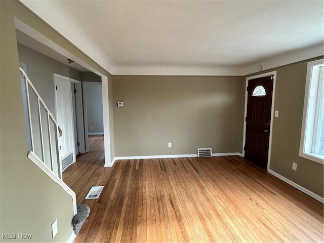 entryway with hardwood / wood-style flooring and a wealth of natural light