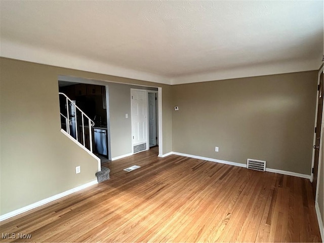 spare room featuring hardwood / wood-style floors