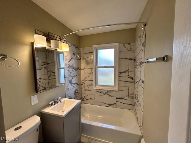 full bathroom with toilet, vanity, and tiled shower / bath