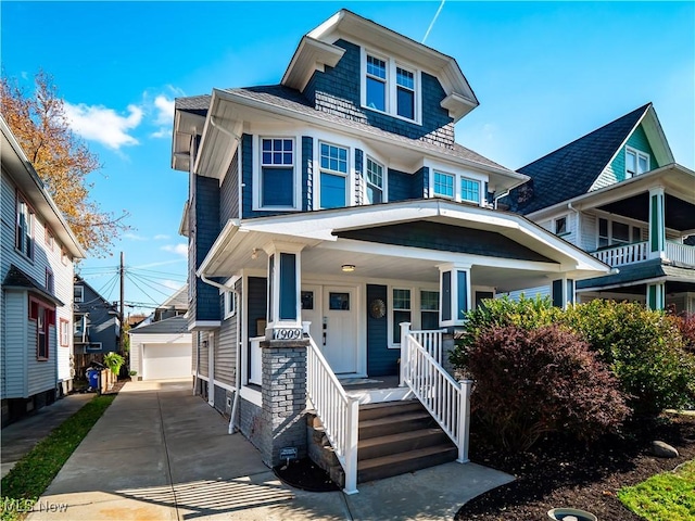 view of front of property featuring covered porch, a garage, and an outdoor structure