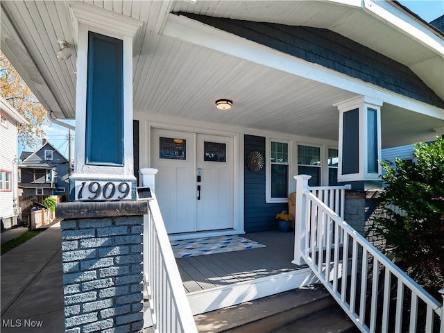 view of exterior entry featuring a porch