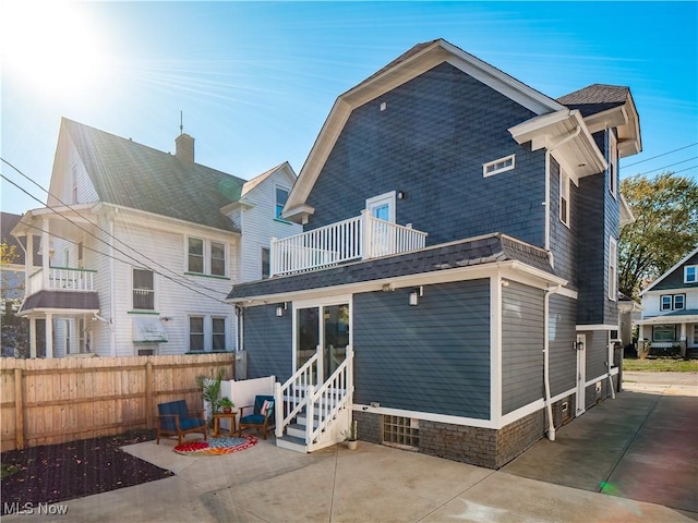 back of house with a patio and a balcony