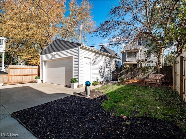 view of home's exterior featuring a lawn, an outbuilding, and a garage