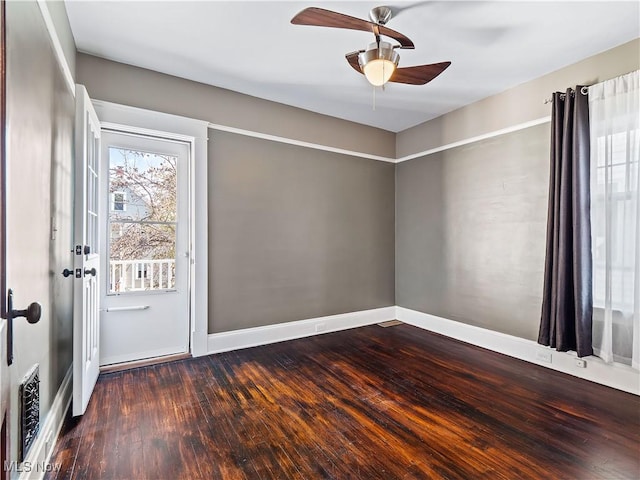 spare room with ceiling fan and dark wood-type flooring