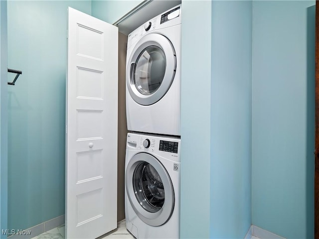 clothes washing area featuring stacked washer / drying machine