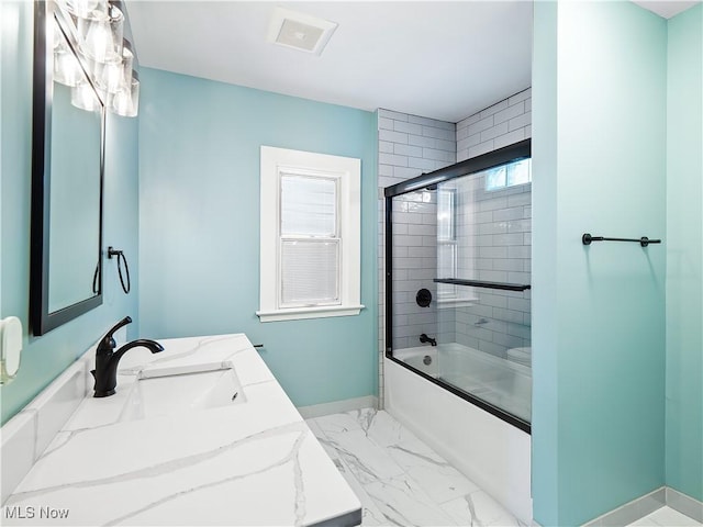 bathroom featuring vanity and combined bath / shower with glass door