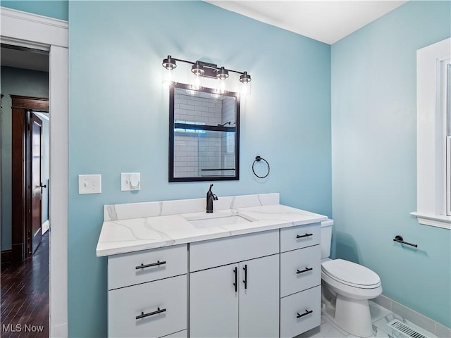 bathroom with vanity and toilet