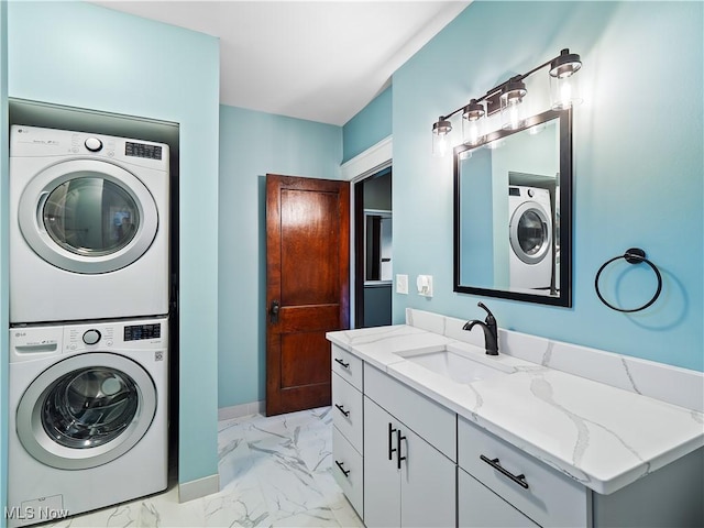 laundry area featuring sink and stacked washer and clothes dryer