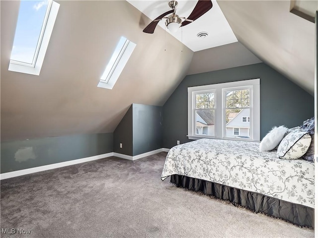 bedroom featuring ceiling fan, carpet floors, and lofted ceiling with skylight