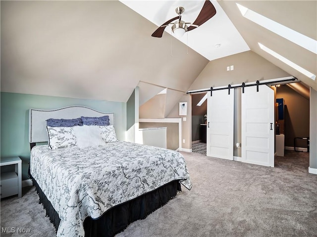 carpeted bedroom with ceiling fan, a barn door, and lofted ceiling with skylight