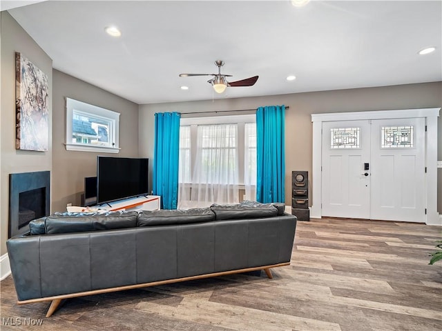 living room with hardwood / wood-style flooring and ceiling fan