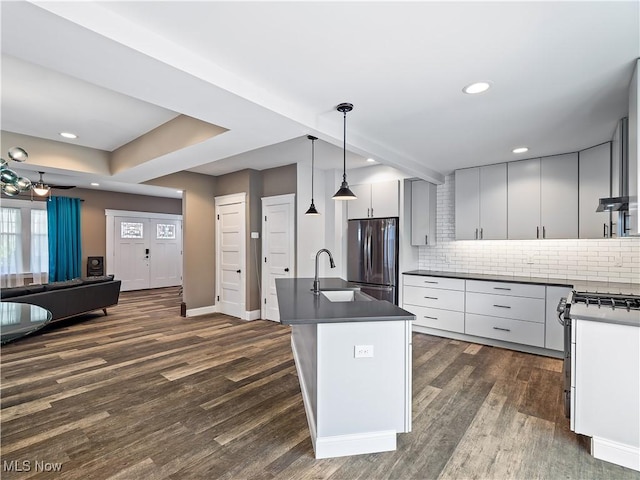 kitchen with pendant lighting, backsplash, dark hardwood / wood-style flooring, and stainless steel appliances