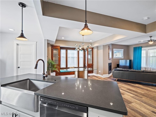 kitchen with dishwasher, hanging light fixtures, a notable chandelier, and sink