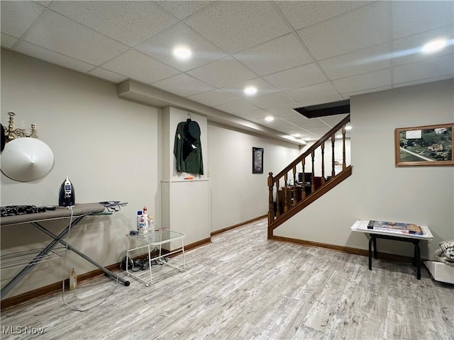 interior space featuring a paneled ceiling and hardwood / wood-style floors