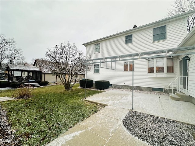 back of property with a patio area and a lawn