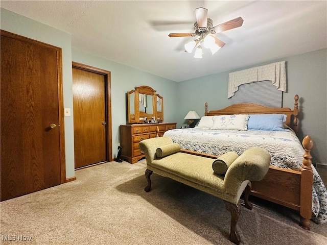 bedroom with ceiling fan and carpet floors