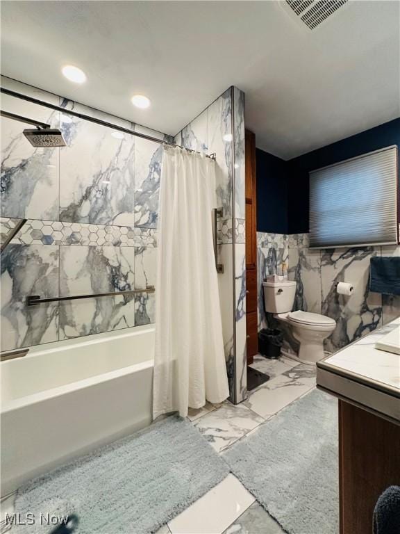 full bathroom with vanity, shower / bath combination with curtain, tile walls, and toilet