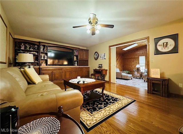 living room featuring ceiling fan and light hardwood / wood-style floors