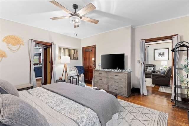 bedroom featuring ceiling fan, crown molding, and light hardwood / wood-style flooring