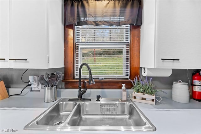 kitchen featuring white cabinetry and sink