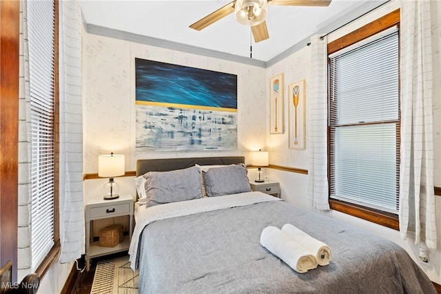 bedroom featuring ceiling fan and ornamental molding