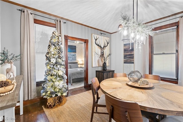 dining space featuring dark hardwood / wood-style flooring and ornamental molding