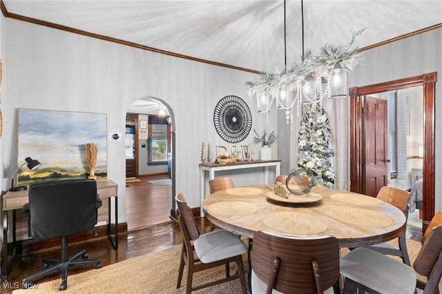 dining area featuring dark hardwood / wood-style flooring and crown molding