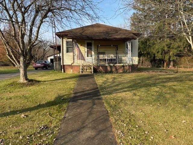 bungalow-style house with a front lawn and a porch