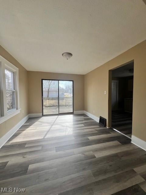 unfurnished room featuring dark wood-type flooring