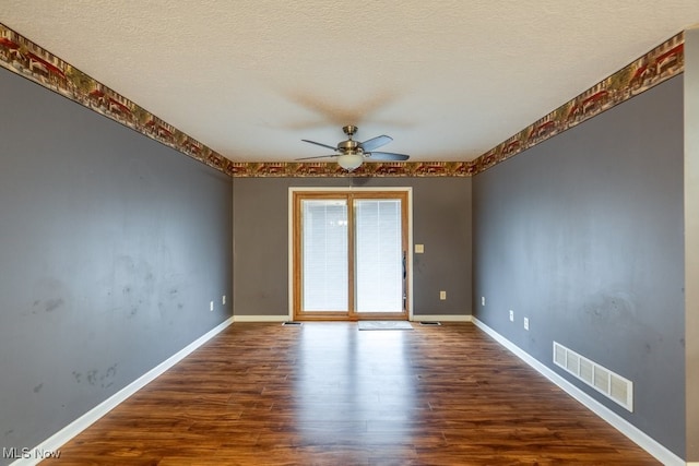 empty room featuring hardwood / wood-style floors, ceiling fan, and a textured ceiling