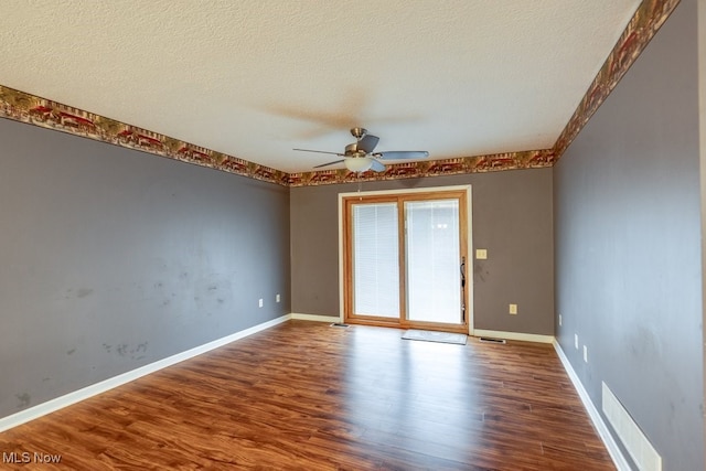 unfurnished room with ceiling fan, hardwood / wood-style floors, and a textured ceiling