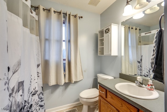 bathroom featuring a shower with curtain, vanity, and toilet