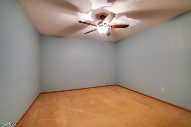 carpeted empty room with a textured ceiling and ceiling fan