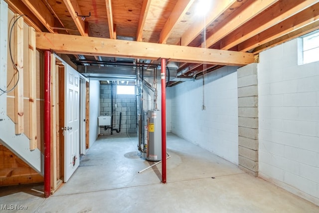 basement featuring water heater and sink