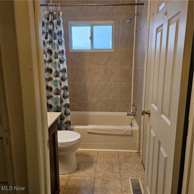 full bathroom featuring shower / bath combo, vanity, and toilet