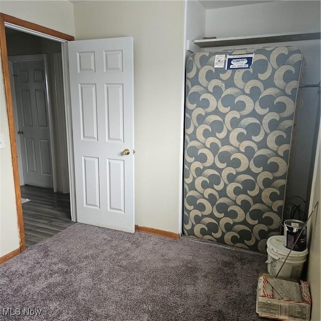 unfurnished bedroom featuring dark colored carpet