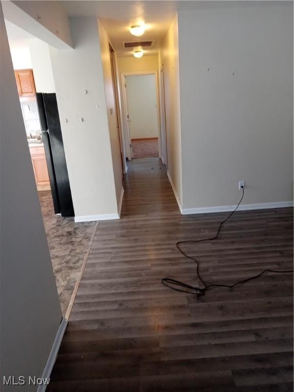 hallway featuring dark hardwood / wood-style flooring