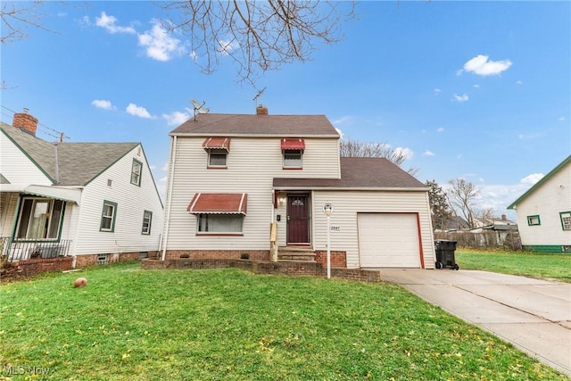 view of front of property with a front yard and a garage