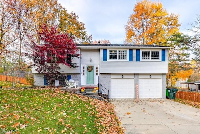 split foyer home featuring a front yard and a garage