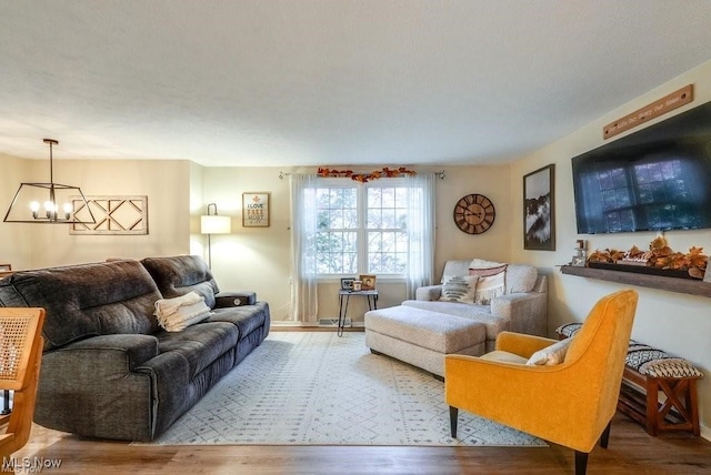 living room featuring wood-type flooring and an inviting chandelier