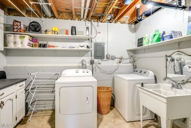 clothes washing area featuring separate washer and dryer, sink, and electric panel